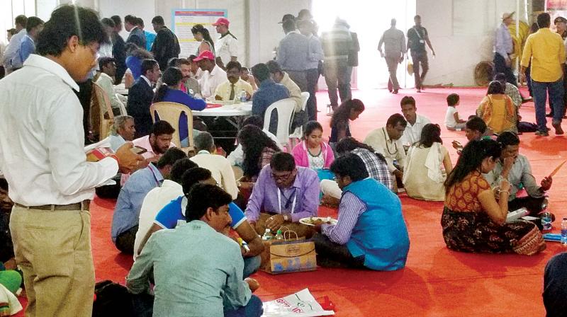Visitors eat on the floor due to lack of seating. (Photo: DC) Visitors eat on the floor due to lack of seating. (Photo: DC)