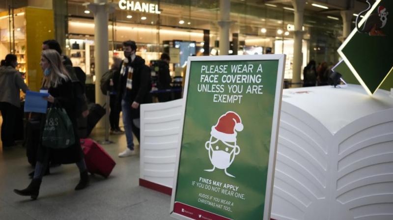A sign asking people to wear face coverings to curb the spread of coronavirus at London St Pancras International rail station, in London, the Eurostar hub to travel to European countries including France, Friday, Dec. 17, 2021.  (AP/Matt Dunham)