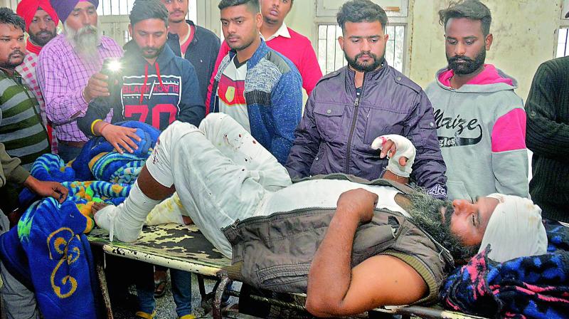 A man injured in a blast at Nirankari Bhawan, a prayer hall in nearby Adliwal village receives treatment at a hospital in Amritsar, on Sunday. (Image: AP) A man injured in a blast at Nirankari Bhawan, a prayer hall in nearby Adliwal village receives treatment at a hospital in Amritsar, on Sunday. (Image: AP)