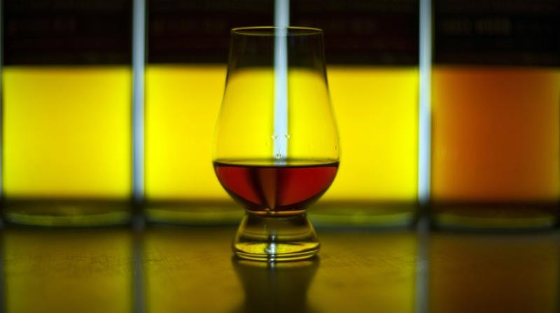 Whisky is poured over a chequerboard pattern of tiny pieces of gold and aluminium and researchers then measure how they absorb light while submerged. (Photo: AFP) Whisky is poured over a chequerboard pattern of tiny pieces of gold and aluminium and researchers then measure how they absorb light while submerged. (Photo: AFP)