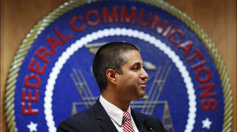 After a meeting voting to end net neutrality, Federal Communications Commission (FCC) Chairman Ajit Pai smiles while listening to a question from a reporter in Washington. The FCC has set June 11 as the repeal date for “net neutrality” rules meant to prevent broadband companies from exercising more control over what people watch and see on the internet. (AP Photo/Jacquelyn Martin, File) After a meeting voting to end net neutrality, Federal Communications Commission (FCC) Chairman Ajit Pai smiles while listening to a question from a reporter in Washington. The FCC has set June 11 as the repeal date for “net neutrality” rules meant to prevent broadband companies from exercising more control over what people watch and see on the internet. (AP Photo/Jacquelyn Martin, File)