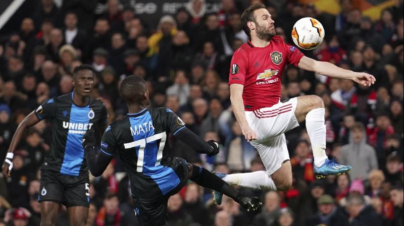 Manchester Uniteds Juan Mata (R) controls the ball ahead of Brugges Clinton Mata during the round of 32 second leg Europa League match at Old Trafford in Manchester, England, on Feb. 27, 2020. AP Photo