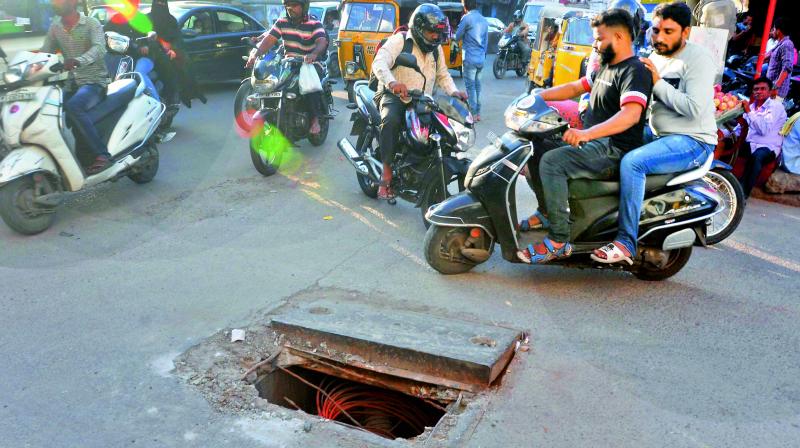 For the last 10 days, a BSNL manhole is left wide open at the Esmaiabazar main road, risking lives of people. (Photo: P. Surendra) For the last 10 days, a BSNL manhole is left wide open at the Esmaiabazar main road, risking lives of people. (Photo: P. Surendra)