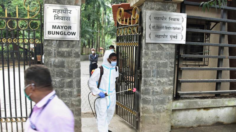 BMC workers sanitize the gate of Mumbai Mayor Kishori Pednekars bungalow after she was tested positive for COVID-19 and quarantined herself at home, in Mumbai, Friday. (PTI)