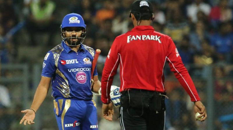 During the tenth over of the Mumbai Indians' innings, Rohit Sharma was given out LBW by umpire CK Nandan, following which the batsman was seen gesturing angrily and showing his bat to the umpire as he walked away. (Photo: BCCI) During the tenth over of the Mumbai Indians' innings, Rohit Sharma was given out LBW by umpire CK Nandan, following which the batsman was seen gesturing angrily and showing his bat to the umpire as he walked away. (Photo: BCCI)