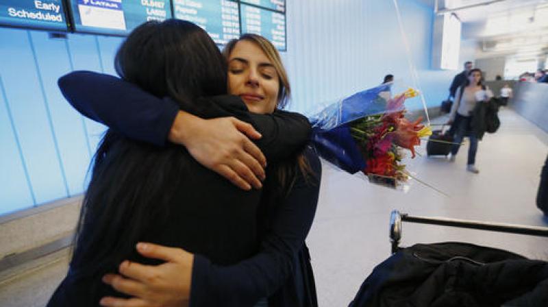 California student Sara Yarjani, right, is welcomed by her sister Sahar Muranovic after arriving at the Tom Bradley International Terminal at Los Angeles International Airport. (Photo: AP) California student Sara Yarjani, right, is welcomed by her sister Sahar Muranovic after arriving at the Tom Bradley International Terminal at Los Angeles International Airport. (Photo: AP)
