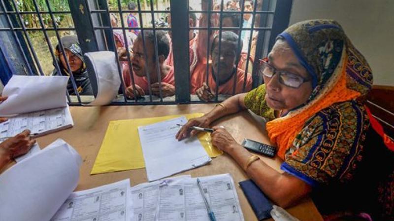 People wait in a queue to check their names on the final draft of the state's National Register of Citizens after it was released, at an NRC Seva Kendra, in Morigaon. (Photo: PTI) People wait in a queue to check their names on the final draft of the state's National Register of Citizens after it was released, at an NRC Seva Kendra, in Morigaon. (Photo: PTI)