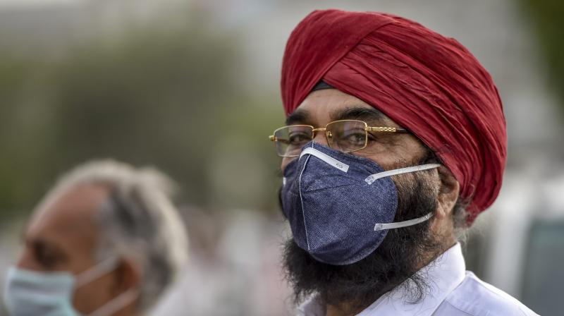 A man wears an anti-pollution mask for protection against air pollution in New Delhi. A thick blanket of haze continued to envelop Delhi and parts of the National Capital Region (NCR). (Photo: PTI) A man wears an anti-pollution mask for protection against air pollution in New Delhi. A thick blanket of haze continued to envelop Delhi and parts of the National Capital Region (NCR). (Photo: PTI)