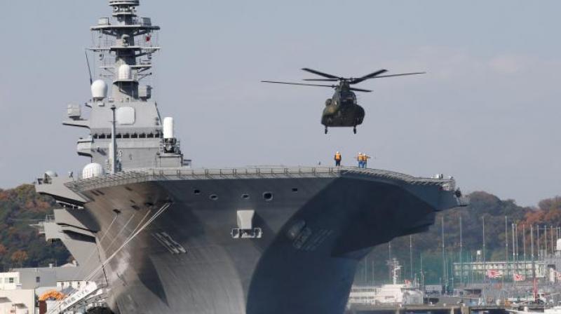 A helicopter lands on the Izumo, Japan Maritime Self Defense Force's (JMSDF) helicopter carrier, at JMSDF Yokosuka base in Yokosuka, south of Tokyo (Photo: Reuters) A helicopter lands on the Izumo, Japan Maritime Self Defense Force's (JMSDF) helicopter carrier, at JMSDF Yokosuka base in Yokosuka, south of Tokyo (Photo: Reuters)