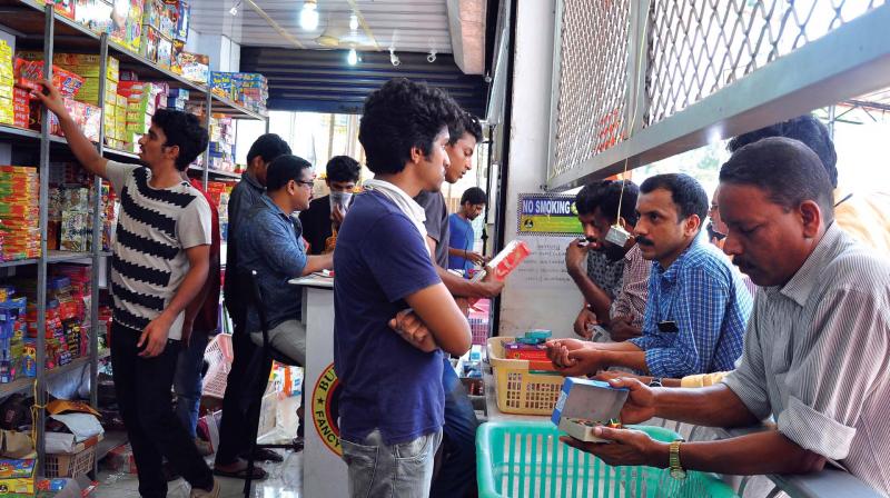 Customers check out crackers at Ayyans store on Koya Road in Kozhikode on Tuesday. Customers check out crackers at Ayyans store on Koya Road in Kozhikode on Tuesday.