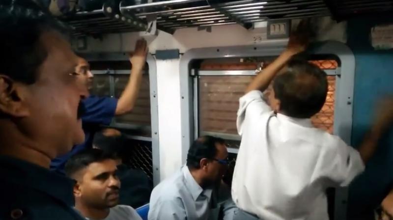 Instead of playing musical instruments, these middle-aged men simply sang and rhythmically beat their hands against the train’s surface. (Credit: Facebook) Instead of playing musical instruments, these middle-aged men simply sang and rhythmically beat their hands against the train’s surface. (Credit: Facebook)