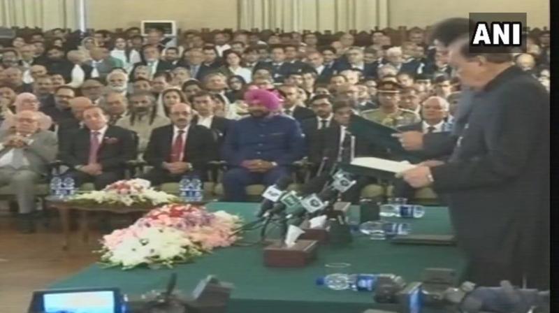 Sidhu arrived in Lahore on Friday via the Wagah border. He travelled from Lahore to Islamabad to attend the ceremony. (Photo: ANI/Twitter) Sidhu arrived in Lahore on Friday via the Wagah border. He travelled from Lahore to Islamabad to attend the ceremony. (Photo: ANI/Twitter)