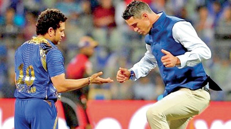 South Africa-born former England batsman Kevin Pietersen with Sachin Tendulkar at an IPL game. DC File Photo