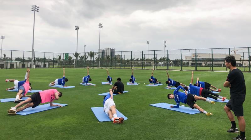 In this handout picture taken on March 16, 2020, and released by Wuhan Three Towns Football Club shows the club players taking part in a training session in Haikou in Chinas southern Hainan province. - Wuhan Three Towns FC, a team in Chinas third division that draws crowds of between 2,000 and 4,000, were gearing up for a promising new season in League Two South when their world was turned upside down. (Photo by Handout / Wuhan Three Towns Football Club / AFP) /