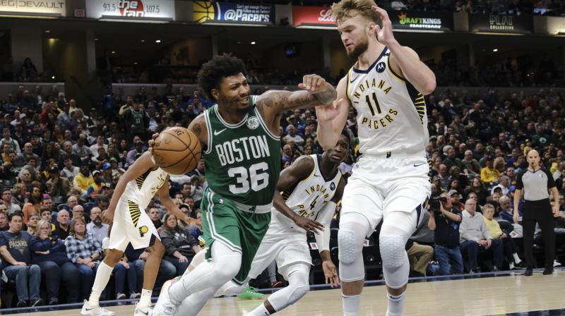 Boston Celtics guard Marcus Smart (36) drives around Indiana Pacers forward Domantas Sabonis (11) during the NBA game in Indianapolis. AP Photo