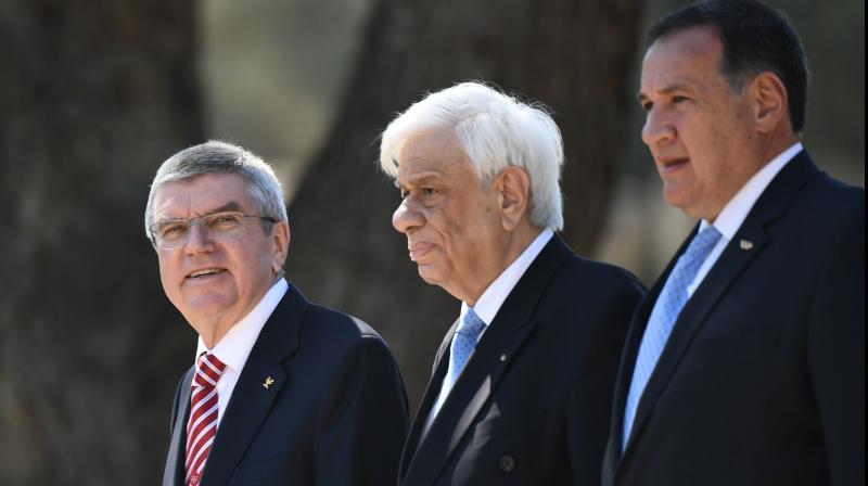 International Olympic Committee (IOC) president Thomas Bach (L) at the Olympic flame lighting ceremony in ancient Olympia on March 12, along with Greek President Prokopis Pavlopoulos (C). AFP Photo International Olympic Committee (IOC) president Thomas Bach (L) at the Olympic flame lighting ceremony in ancient Olympia on March 12, along with Greek President Prokopis Pavlopoulos (C). AFP Photo