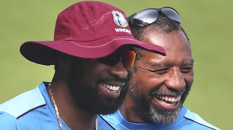 West Indies' captain Kieron Pollard (L) shares a light moment with head coach Phil Simmons. AP Photo West Indies' captain Kieron Pollard (L) shares a light moment with head coach Phil Simmons. AP Photo