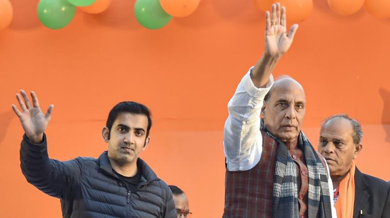 Former India cricketer and current BJP MP Gautam Gambhir with Union Defence Minister Rajnath Singh at a public meeting. PTI Photo