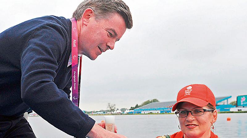 Head of the British Olympic Association Hugh Robertson (L) with Australian Sports Minister Kate Lundy after the latter rowed 1000m of the Olympic course in 2012. AFP Photo