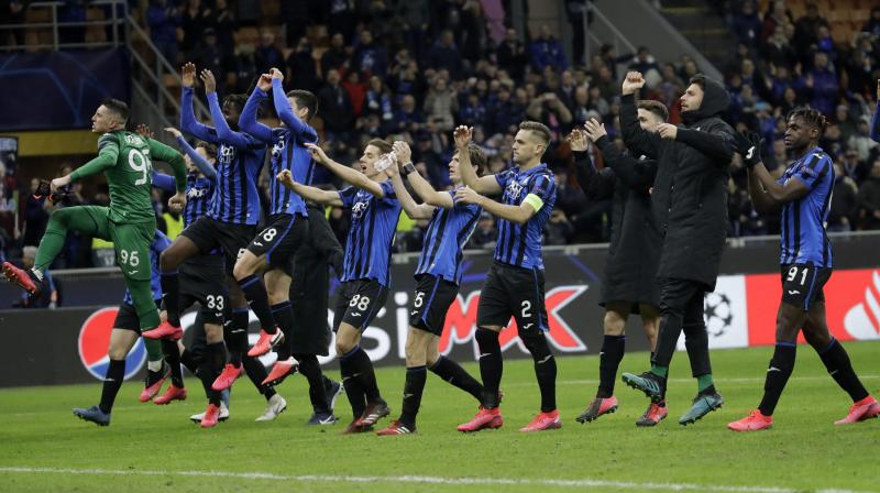 File photo of Atalanta players celebrating at the end of their Champions League round of 16, first leg, win over Valencia at the San Siro stadium in Milan, Italy, February 19. AP Photo