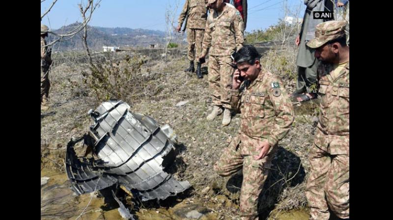 Wreckage of the F-16 Pakistan Air Force jet, which was shot down by the Indian Air Force on Wednesday, was seen being inspected by Pakistan military officers in PoK, sources said. (Photo: ANI) Wreckage of the F-16 Pakistan Air Force jet, which was shot down by the Indian Air Force on Wednesday, was seen being inspected by Pakistan military officers in PoK, sources said. (Photo: ANI)