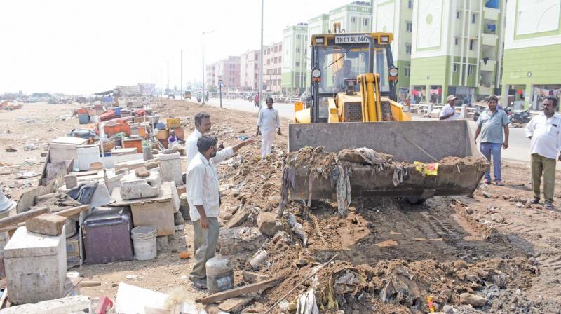 Conservancy workers take up clearing of roadside fish shops on Marina beach service road. —DC Conservancy workers take up clearing of roadside fish shops on Marina beach service road. —DC