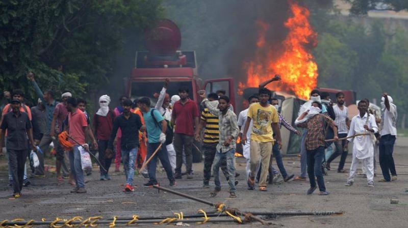 The agitating Dera followers on Friday resorted to damaging public and private properties as well as attacking mediapersons. (Photo: AFP) The agitating Dera followers on Friday resorted to damaging public and private properties as well as attacking mediapersons. (Photo: AFP)