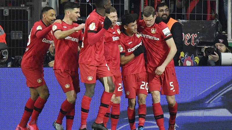 Leverkusens Chilean international Charles Aranguiz (second from right) celebrates with teammates after scoring his teams third goal in a 3-1 win against 10-man Union Berlin in German Cup on Wednesday. AP Photo