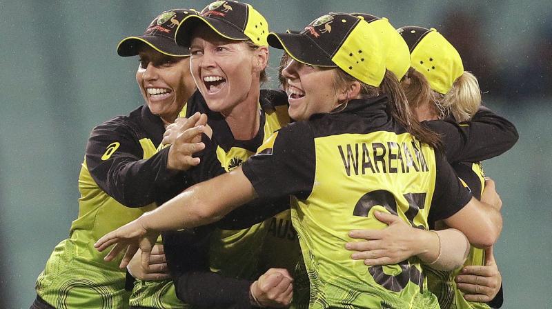 Jubilant Australian cricketers celebrate after winning their Womens T20 World Cup cricket semifinal match against South Africa in Sydney, Thursday, March 5, 2020. (AP Photo/