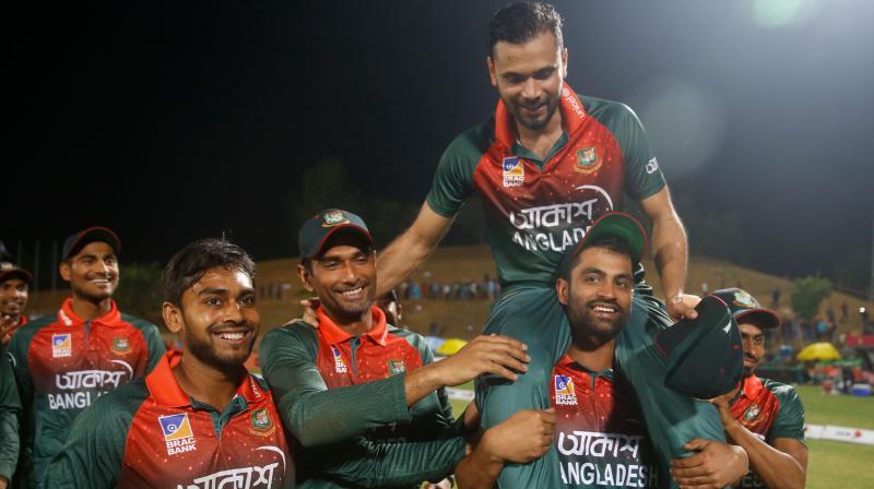 Bangladeshs captain Mashrafe Bin Mortaza is lifted by his teammate Tamim Iqbal after the third one day international against Zimbabwe in Sylhet on Friday. AFP Photo