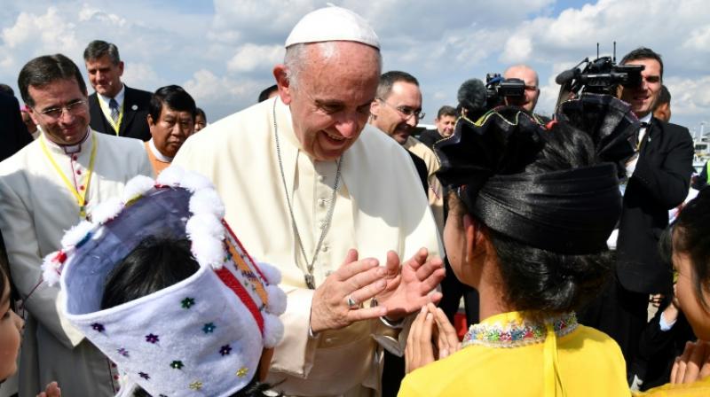Catholics in colourful ethnic traditional dress waved flags and danced at Yangon's airport in a joyful welcome for the pope, making the first visit to the country by a pontiff. (Photo: AFP) Catholics in colourful ethnic traditional dress waved flags and danced at Yangon's airport in a joyful welcome for the pope, making the first visit to the country by a pontiff. (Photo: AFP)