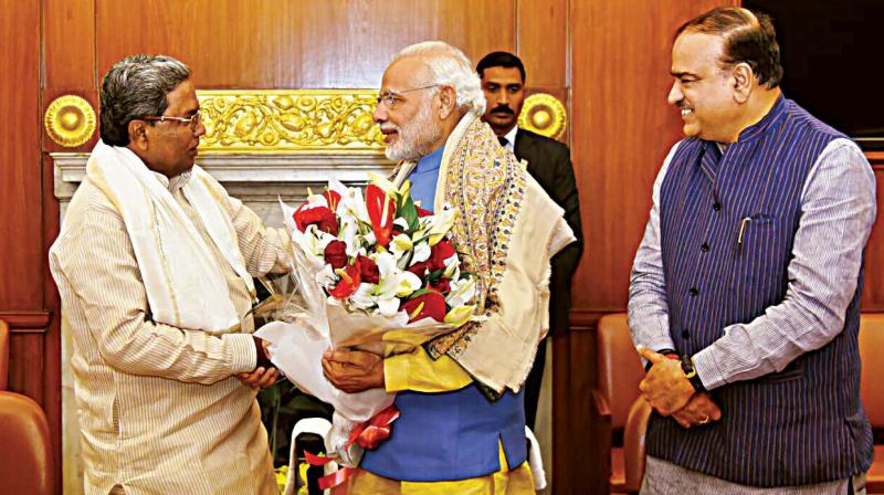 Chief Minister Siddaramaiah greets Prime Minister Narendra Modi in New Delhi on Friday. Chief Minister Siddaramaiah greets Prime Minister Narendra Modi in New Delhi on Friday.