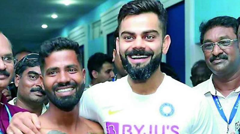 Virat Kohli poses with die-hard fan Pintu Behera, who has 14 tattoos on his body that highlight Kohli’s career so far, in Visakhapatnam. Virat Kohli poses with die-hard fan Pintu Behera, who has 14 tattoos on his body that highlight Kohli’s career so far, in Visakhapatnam.