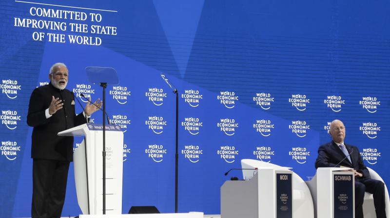PM Modi delivers his speech as Klaus Schwab, Founder and Executive Chairman of the World Economic Forum listens during the opening session of the World Economic Forum, WEF, in Davos, Switzerland. (Photo: AP) PM Modi delivers his speech as Klaus Schwab, Founder and Executive Chairman of the World Economic Forum listens during the opening session of the World Economic Forum, WEF, in Davos, Switzerland. (Photo: AP)