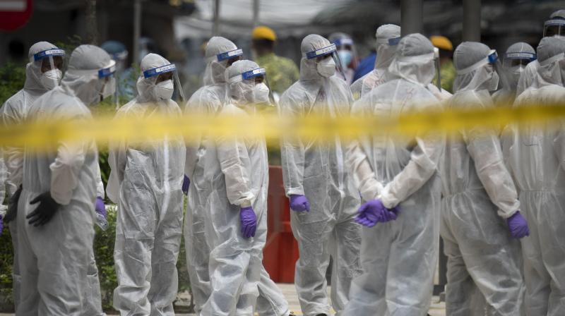 Immigration officers wearing full protection suits prepare at a coronavirus locked down area in Kuala Lumpur, Malaysia. (AP) Immigration officers wearing full protection suits prepare at a coronavirus locked down area in Kuala Lumpur, Malaysia. (AP)