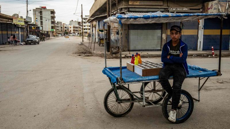 A Syrian man, selling juice, waits for customers in the city of Qamishli in Syrias northeastern Hasakeh province. (AFP)