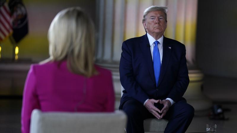 President Donald Trump listens during a Fox News virtual town hall from the Lincoln Memorial. (AP)