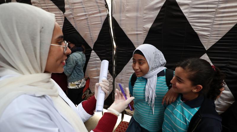 An Egyptian doctor gives medical advice to girls about Female Genital Mutilation (FGM) during an awareness campaign in Giza. (AFP)