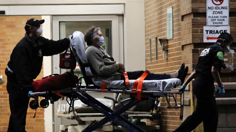 Medical workers take in patients outside a special coronavirus area at Maimonides Medical Center in the Borough Park neighborhood of the Brooklyn borough of New York City. (AFP) Medical workers take in patients outside a special coronavirus area at Maimonides Medical Center in the Borough Park neighborhood of the Brooklyn borough of New York City. (AFP)