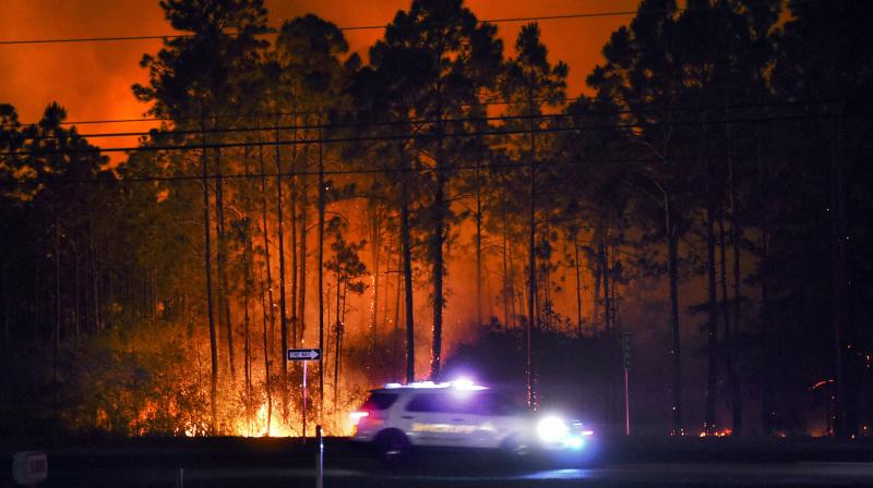 Authorities say firefighters in the Florida Panhandle battled wildfires through the night that have forced hundreds of people to evacuate from their homes. (AP)