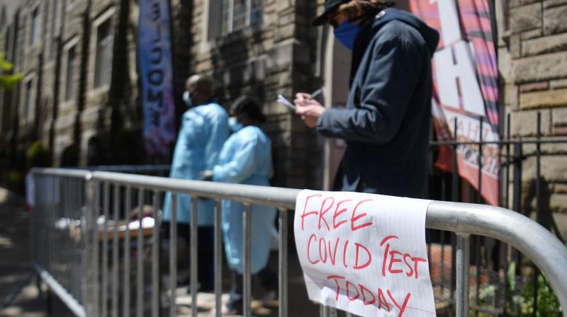 A resident fills out paperwork for a free COVID-19 test at the Bethany Baptist Church in the Brooklyn borough of New York City. (AFP) A resident fills out paperwork for a free COVID-19 test at the Bethany Baptist Church in the Brooklyn borough of New York City. (AFP)