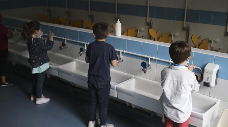 Children wash their hands at the Saint-Tronc Castelroc primary school in Marseille, southern France. (AP)