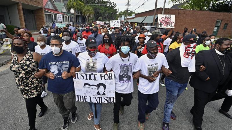 Protesters march after a rally at the Glynn County Courthouse to protest the shooting of Ahmaud Arbery. (AP)