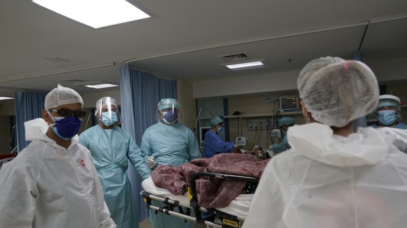 Medical workers attend to a COVID-19 patient at the Sao Jose municipal hospital, in Duque de Caxias, Brazil. (AP)