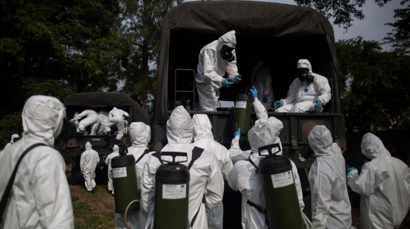 Brazils Armed Forces soldiers prepare to disinfect the public shelter Stella Maris as a measure to combat the outbreak of new novel coronavirus (COVID-19), in Rio de Janeiro. (AFP)