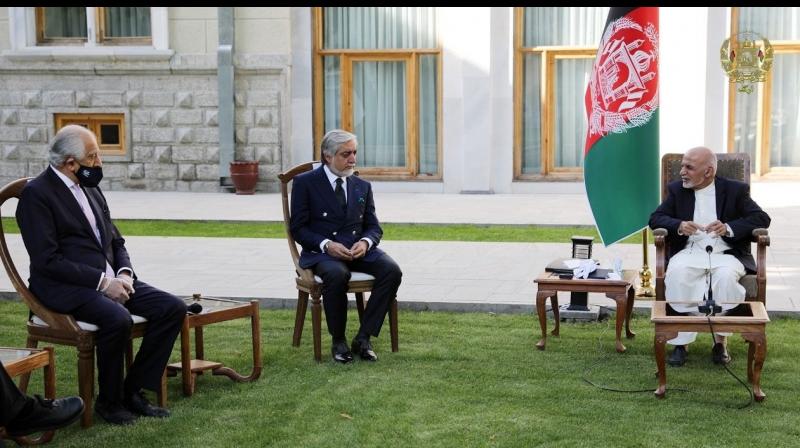 Afghan President Ashraf Ghani, right, and fellow leader under a recently signed power-sharing agreement, Abdullah Abdullah, center, hold a meeting with U.S. peace envoy Zalmay Khalilzad aimed at resuscitating a U.S.-Taliban peace deal signed in February, at the Presidential Palace, in Kabul, Afghanistan. (The Presidential Palace via AP)