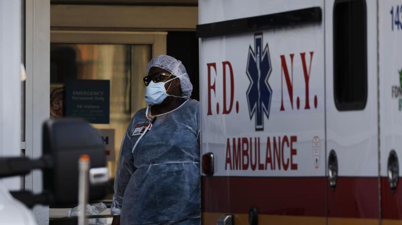 Medical workers take in patients outside a special coronavirus area at Maimonides Medical Center as the U.S. surpasses 100,000 fatalities from COVID-19 on May 27, 2020 in New York City. (AFP)