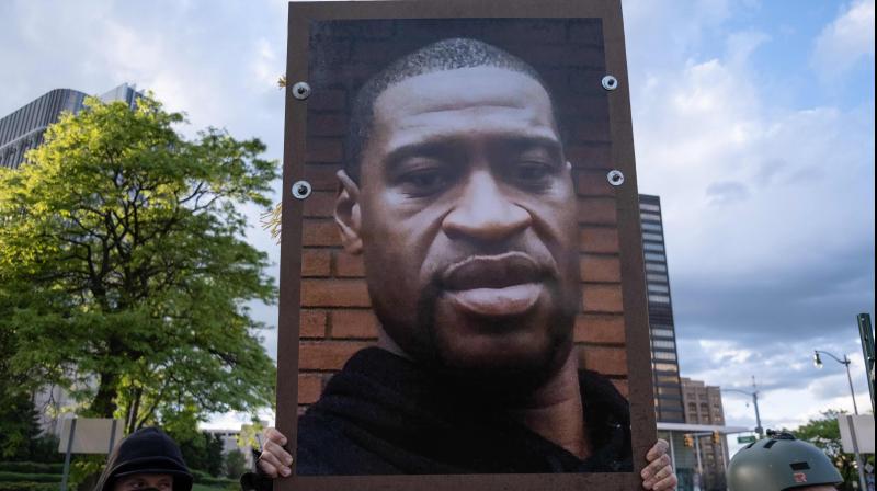 Protestors hold a picture of George Floyd at a protest in Detroit, Michigan. (AFP) Protestors hold a picture of George Floyd at a protest in Detroit, Michigan. (AFP)