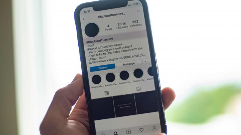 A smartphone displaying the Instagram #blackouttuesday account is seen in Washington on June 2, 2020. (AFP)