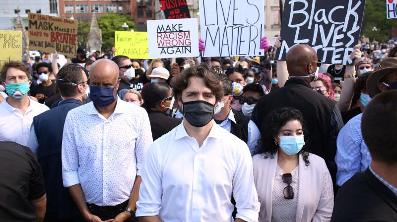 Canadadian Prime Minister Justin Trudeau (C) takes part in a Black Lives Matter protest on Parliament Hill.(AFP)